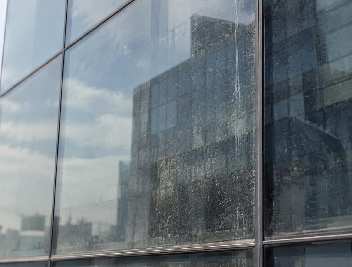 Commercial glass facade with dust and water marks